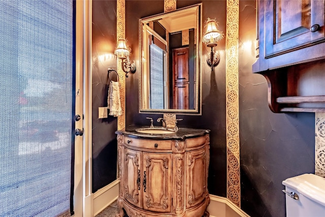 bathroom featuring toilet and vanity