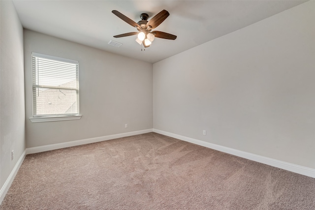 carpeted spare room featuring ceiling fan