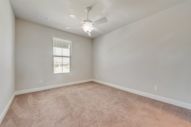 carpeted spare room with ceiling fan