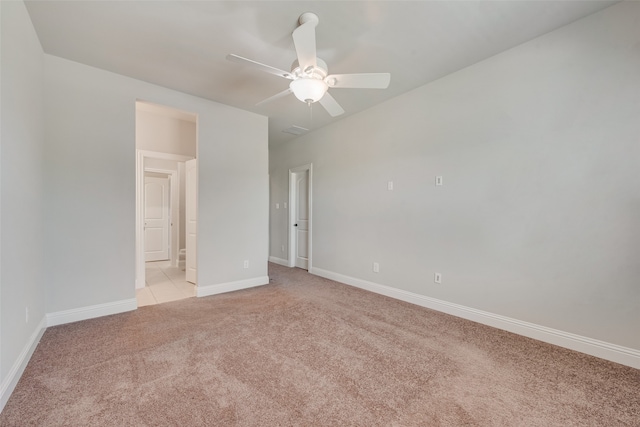 empty room with ceiling fan and light carpet