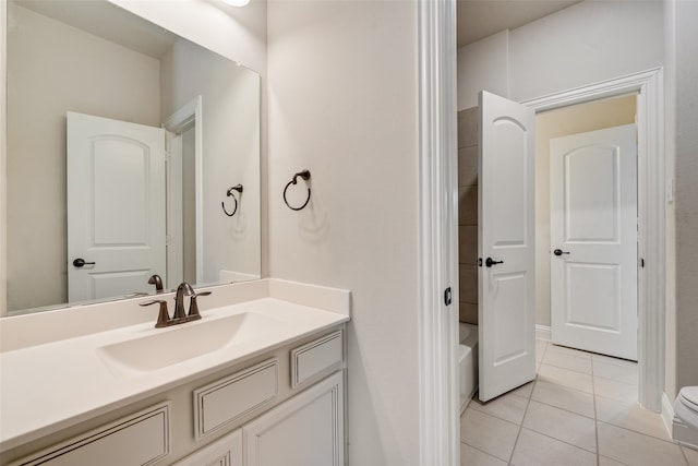 bathroom featuring a tub to relax in, tile patterned flooring, vanity, and toilet