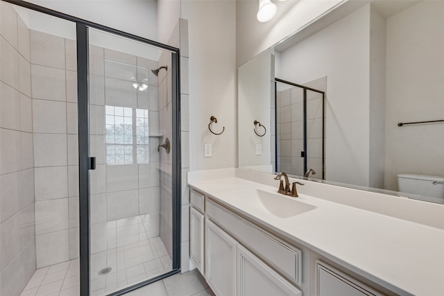 bathroom with a shower with door, vanity, and toilet