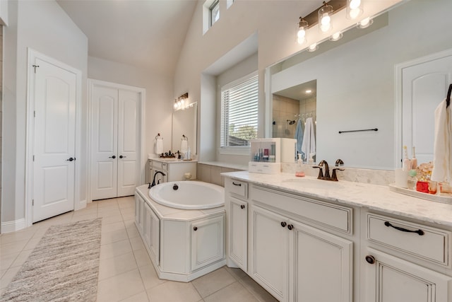 bathroom featuring vanity, vaulted ceiling, separate shower and tub, and tile patterned flooring