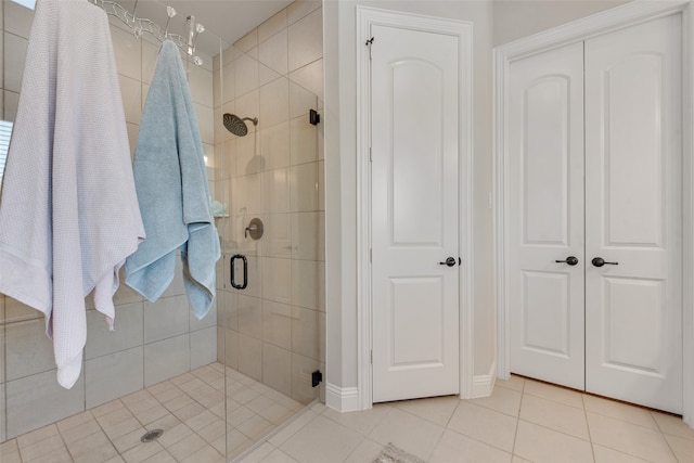 bathroom with tile patterned flooring and walk in shower