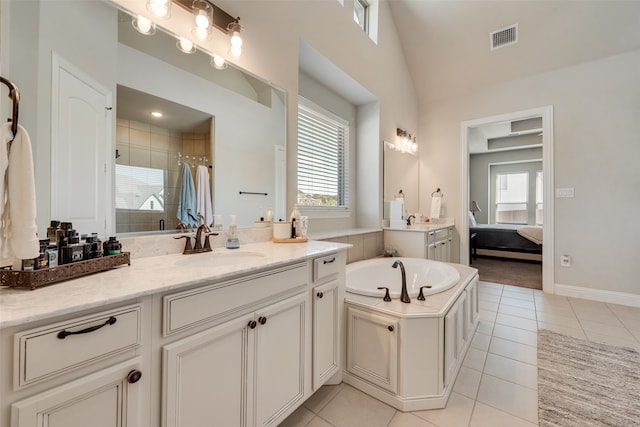 bathroom with plus walk in shower, lofted ceiling, tile patterned floors, and vanity