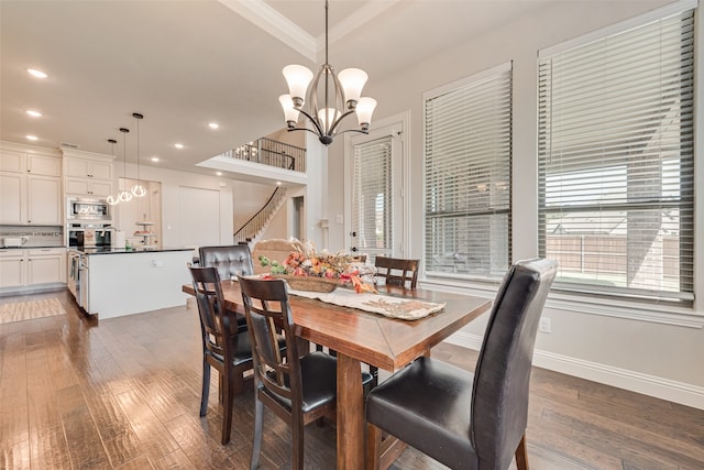 dining space with dark wood-type flooring and a notable chandelier