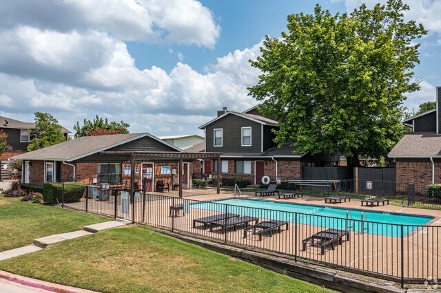 view of swimming pool featuring a yard and a patio