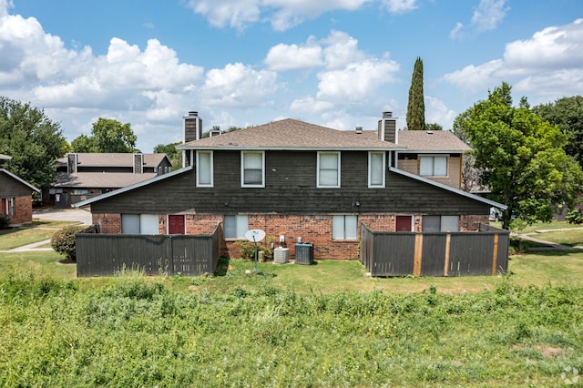 rear view of house with cooling unit