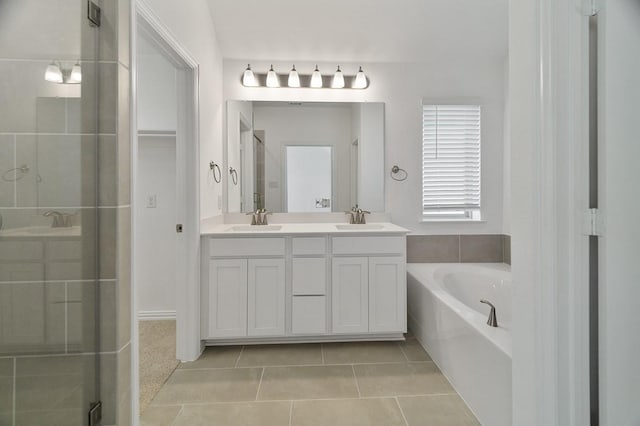 bathroom with tile patterned flooring, vanity, and separate shower and tub