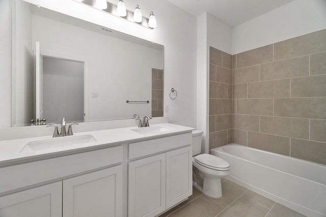 full bathroom with tile patterned floors, vanity, toilet, and tiled shower / bath combo