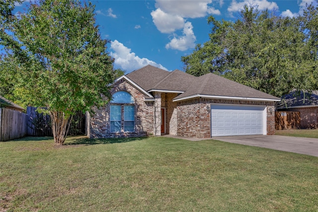 view of front of property with a garage and a front lawn