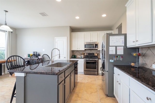 kitchen with appliances with stainless steel finishes and white cabinetry