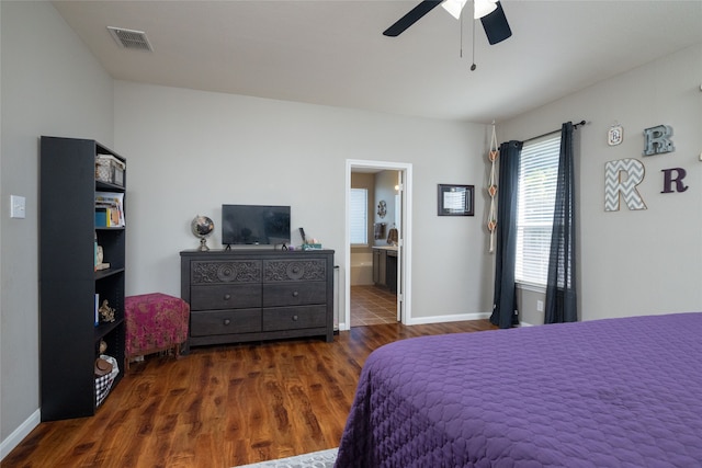 bedroom with dark hardwood / wood-style floors, ensuite bath, and ceiling fan