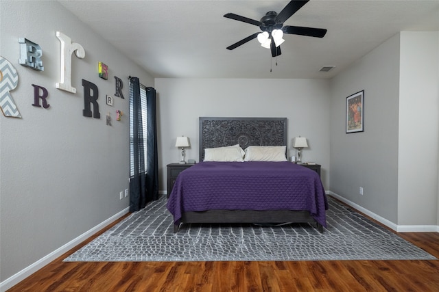 bedroom with ceiling fan and dark wood-type flooring