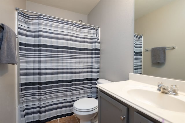 bathroom featuring tile patterned floors, vanity, a shower with shower curtain, and toilet