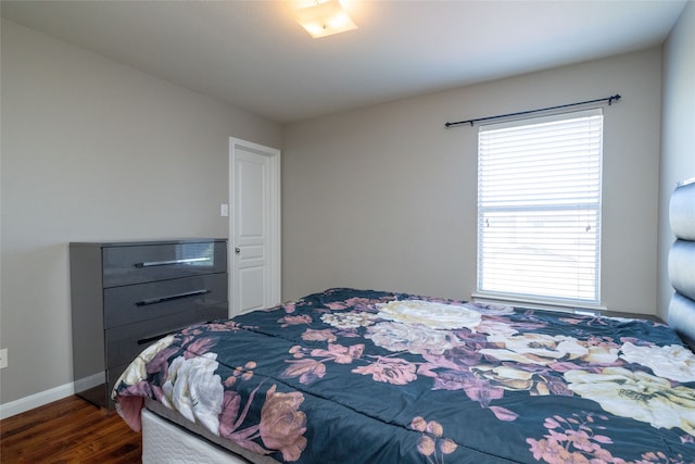 bedroom featuring multiple windows and dark wood-type flooring