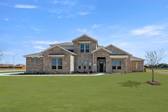 view of front of home with brick siding and a front yard