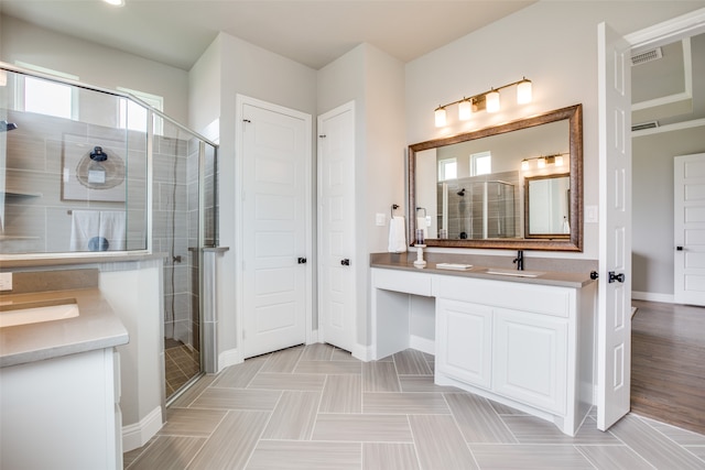 bathroom featuring wood-type flooring, vanity, and a shower with shower door