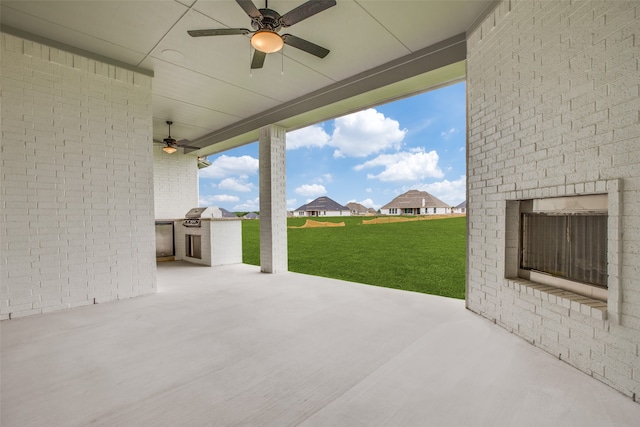 view of patio / terrace featuring ceiling fan and exterior kitchen