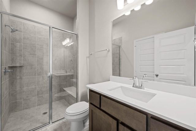 full bathroom with toilet, a shower stall, and vanity