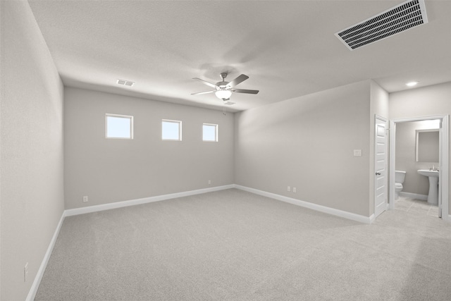 unfurnished room featuring light carpet, visible vents, and baseboards