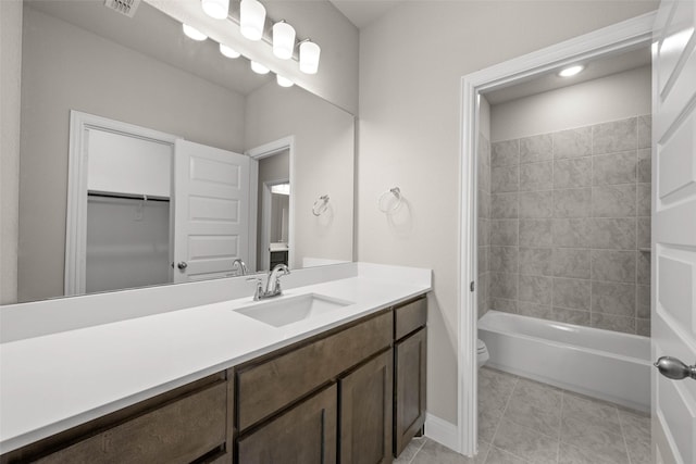 bathroom with toilet, visible vents, tile patterned flooring, and vanity