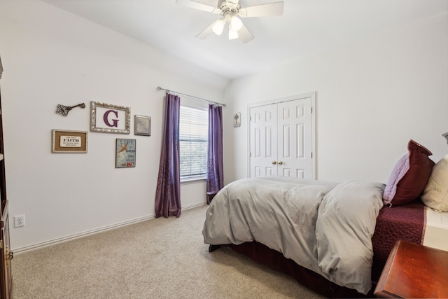 carpeted bedroom featuring ceiling fan and a closet