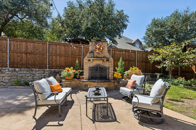 view of patio / terrace featuring an outdoor stone fireplace