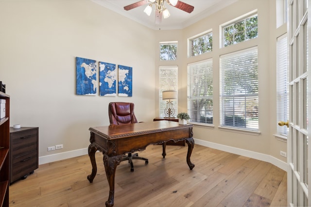 office area with ceiling fan, light hardwood / wood-style flooring, crown molding, and a wealth of natural light