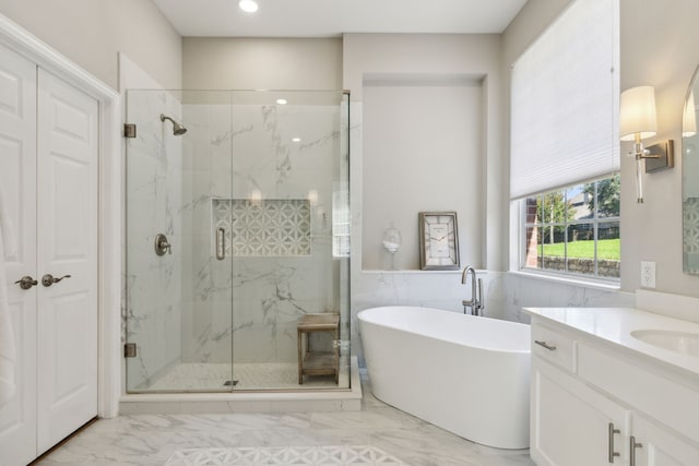 bathroom with shower with separate bathtub and vanity