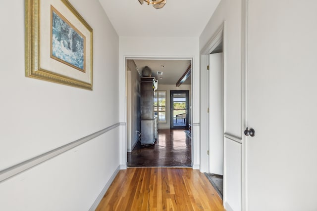 hallway with hardwood / wood-style flooring