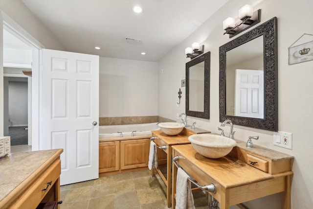 bathroom with vanity and a bathtub