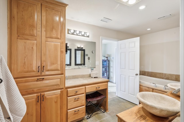 bathroom featuring a tub to relax in and vanity