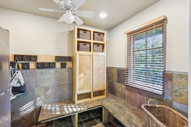 bathroom featuring tile walls and ceiling fan