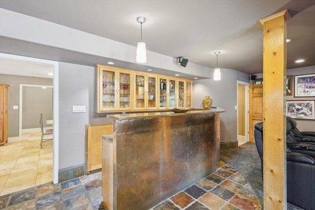 kitchen featuring light brown cabinets and hanging light fixtures