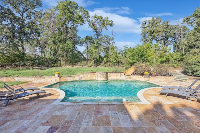 view of pool featuring a yard and a patio area