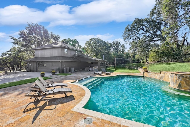 view of pool with a patio and a yard