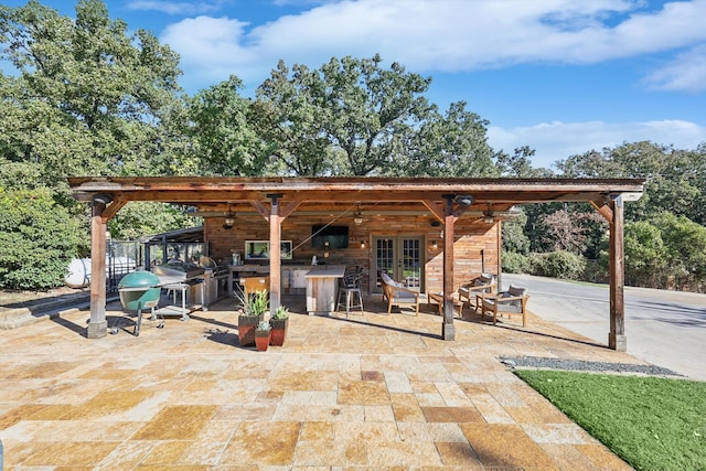 view of patio / terrace featuring ceiling fan and french doors