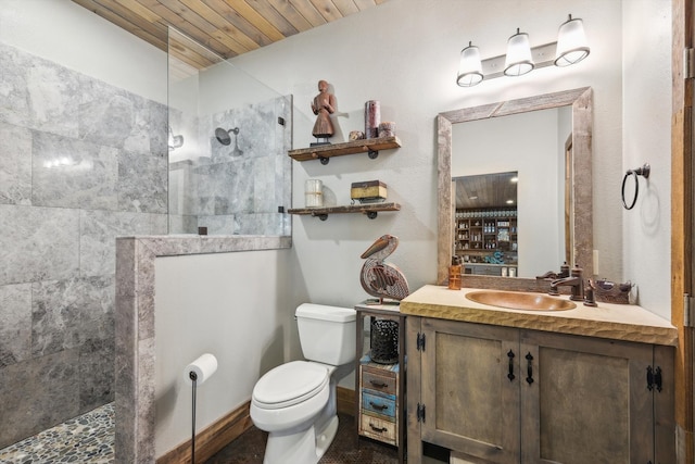 bathroom with vanity, toilet, wooden ceiling, and tiled shower