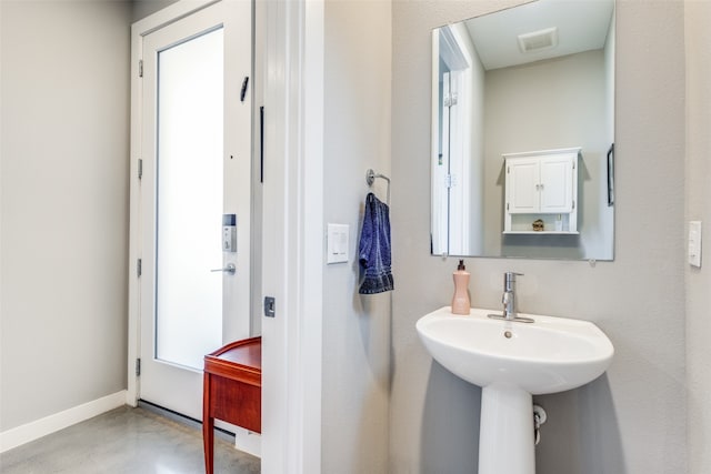 bathroom with concrete flooring