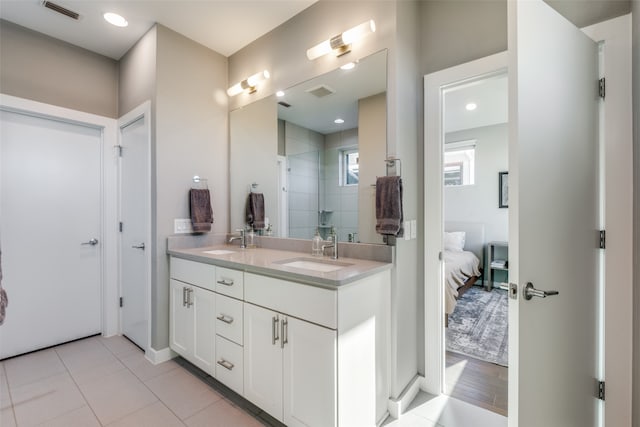 bathroom with a tile shower, vanity, and hardwood / wood-style flooring