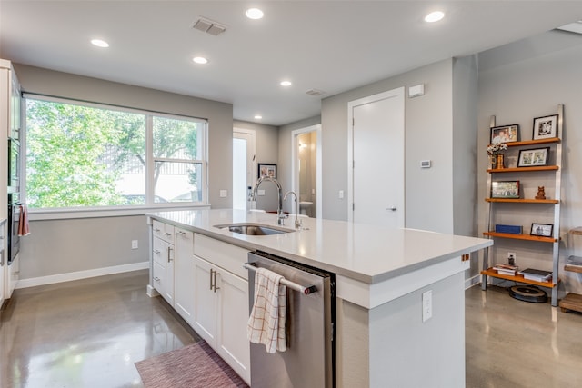 kitchen with white cabinets, sink, concrete floors, and stainless steel dishwasher