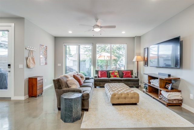 living room with ceiling fan and concrete floors