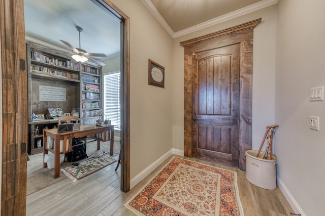 foyer entrance featuring light wood-type flooring, crown molding, and ceiling fan