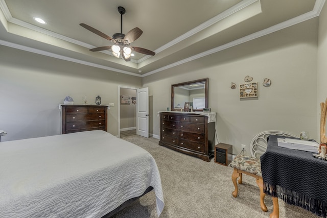 carpeted bedroom featuring ceiling fan, a raised ceiling, and ornamental molding