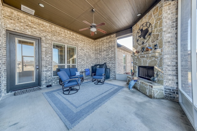 view of patio / terrace featuring an outdoor living space with a fireplace and ceiling fan