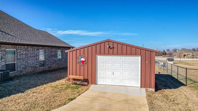 garage with cooling unit, wood walls, and a yard