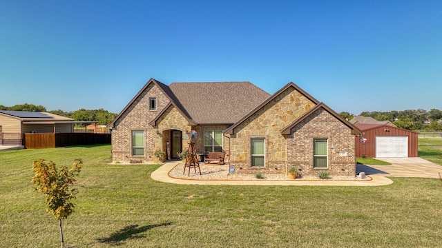 view of front of home featuring a garage and a front yard