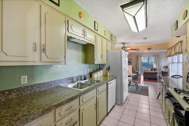 kitchen with black gas range, white dishwasher, sink, ceiling fan, and light tile patterned floors