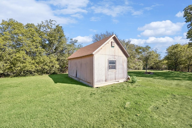 view of outbuilding with a yard